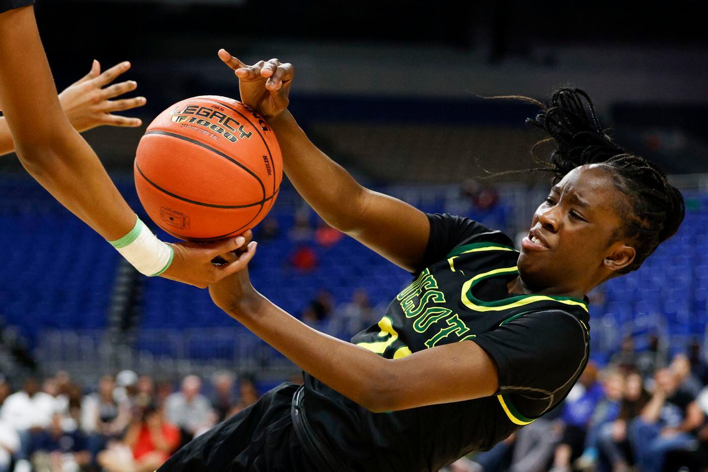 DeSoto guard Nisaa Muhammad (23) falls to the ground as she reaches for a loose ball during...
