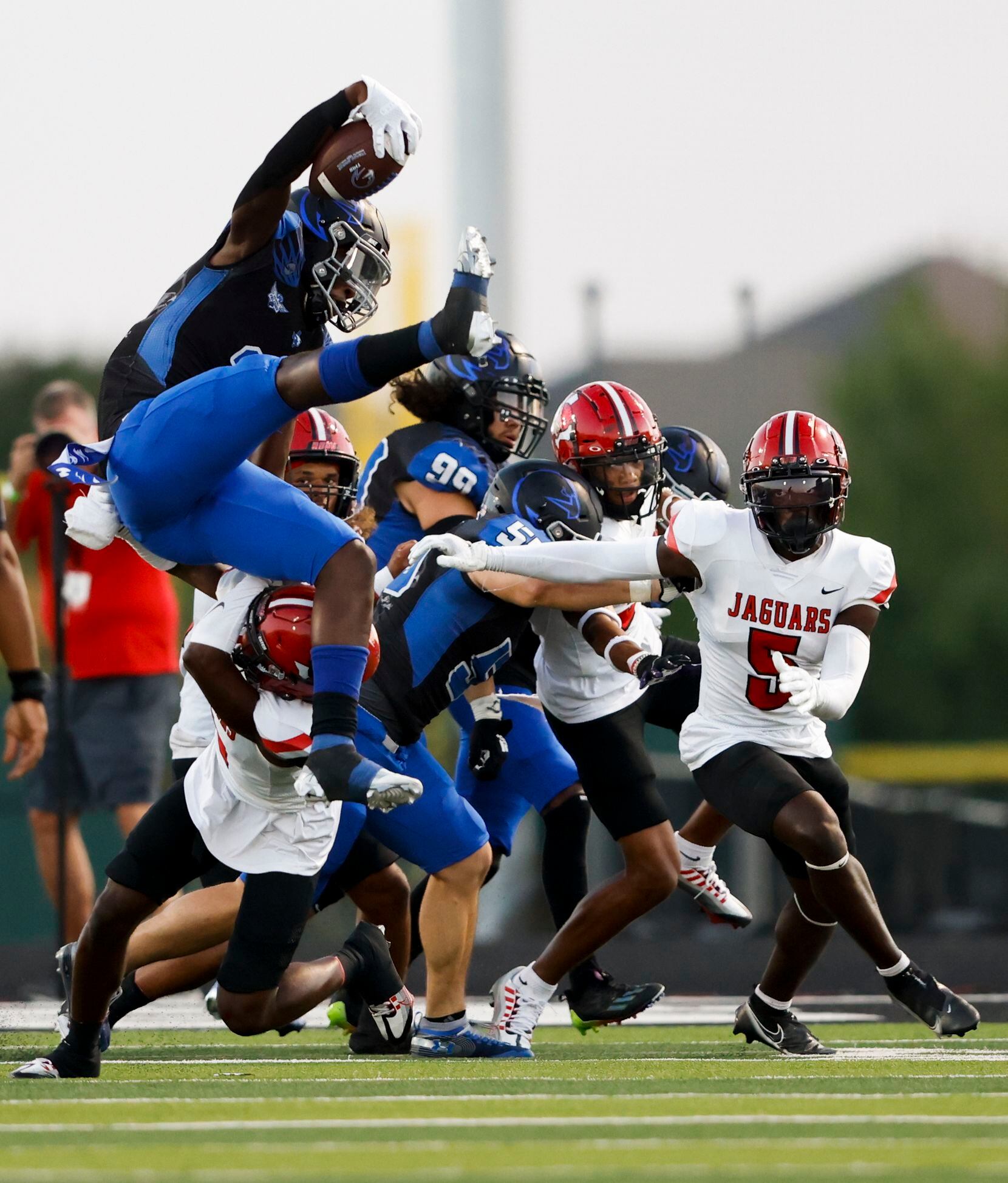 North Forney’s Ernest Thomas (2) jumps over Mesquite Horn’s defensive back Amarion Atwood...