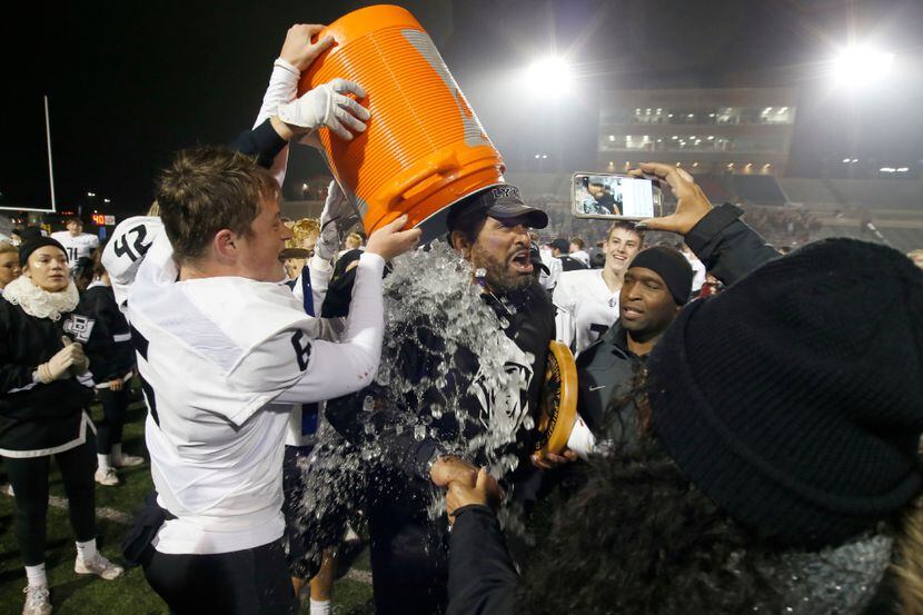 Bishop Lynch coach Chuck Faucette gets a bucket of ice dumped on him by Samuel Vrana after a...