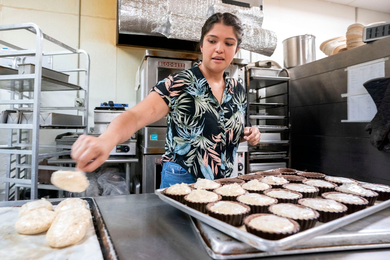 Maricsa Trejo, owner and pastry chef at La Casita Bakeshop, takes pie weights out of pie...