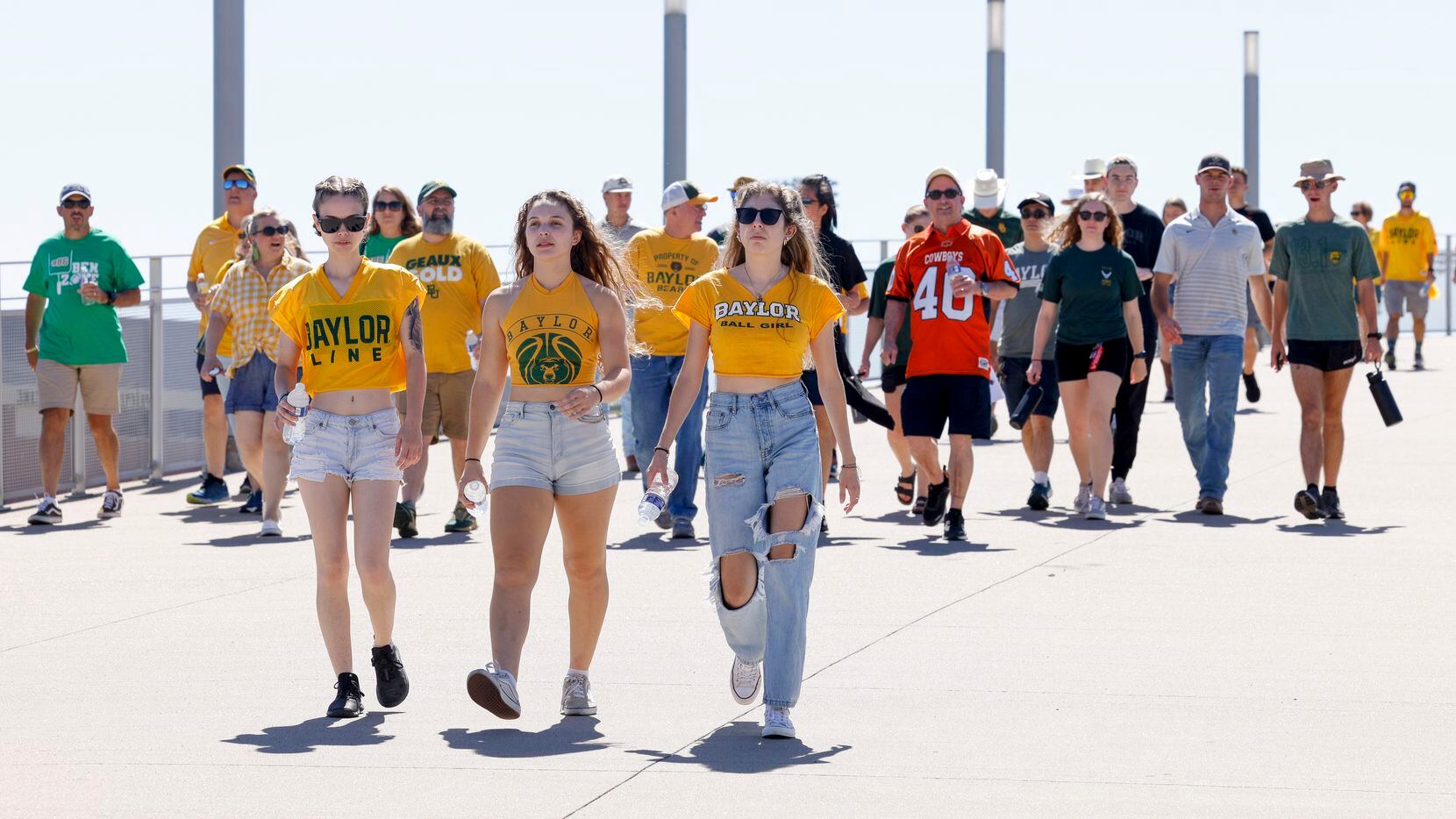 Fans cross over the Brazos River before an NCAA football game between Baylor University and...