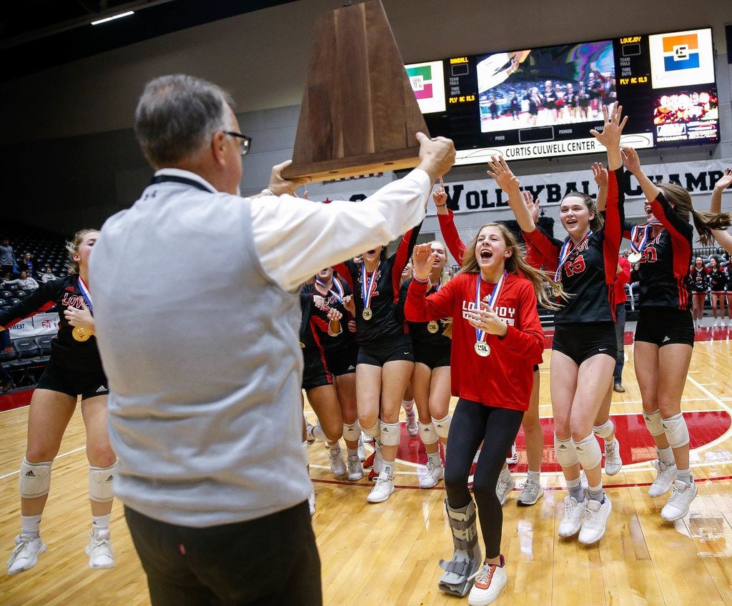 The Lucas Lovejoy Leopards run to accept their trophy after winning a class 5A volleyball...