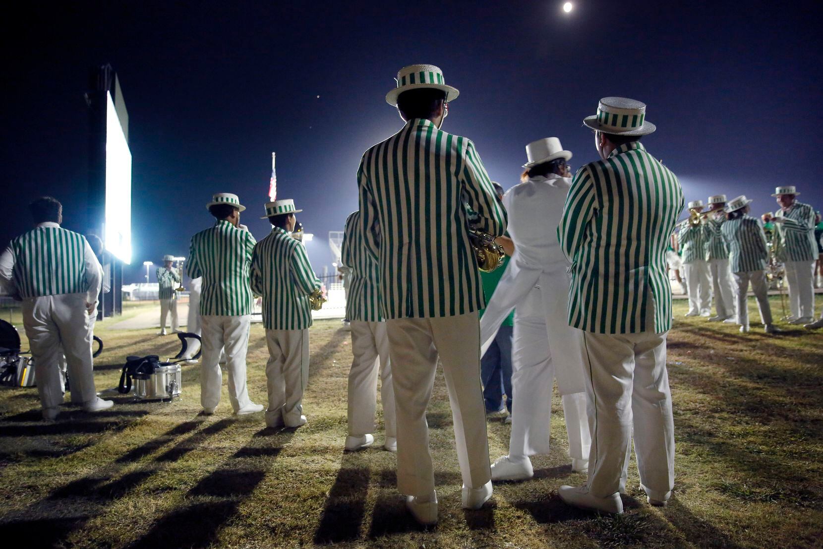 Members of the Bryan Adams High marching band wait to perform during halftime of the W.T....