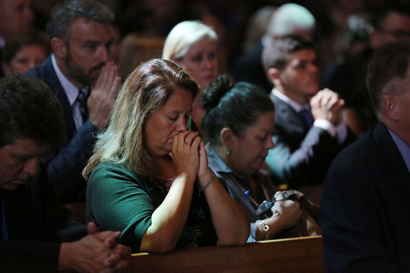 Worshippers mourn during the funeral for Dallas police sergeant Michael Smith.