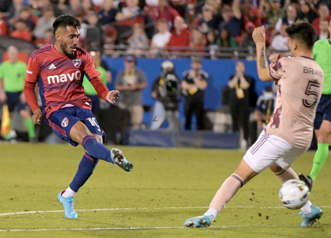 FC Dallas forward Jesús Ferreira (10) scores his third goal of the game between the legs of...
