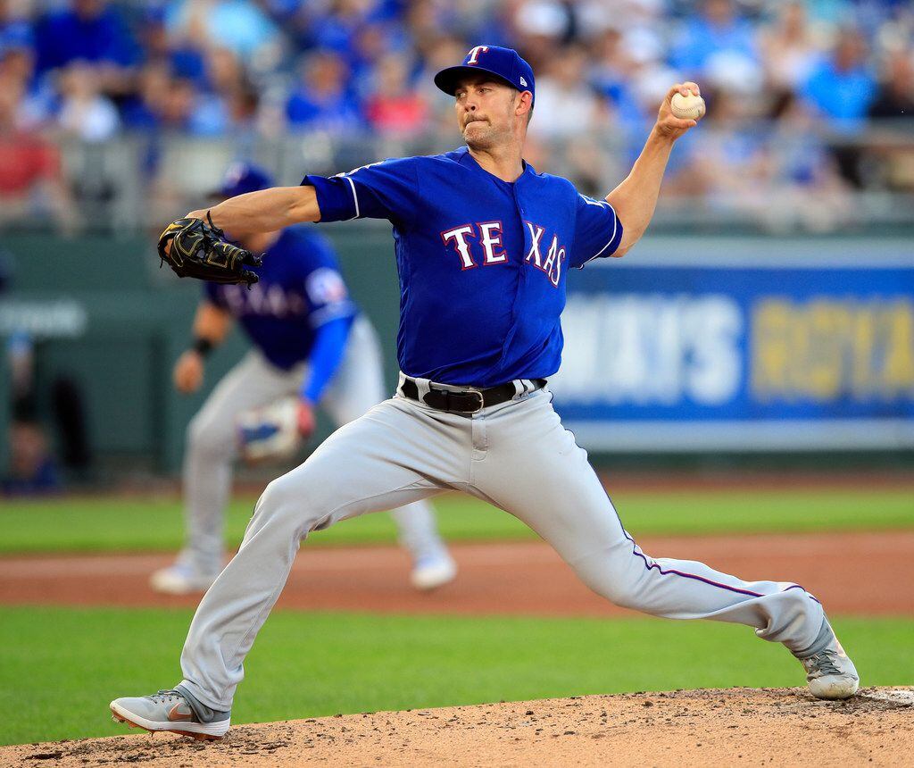 Texas Rangers starting pitcher Mike Minor delivers to a Kansas City Royals batter during the...