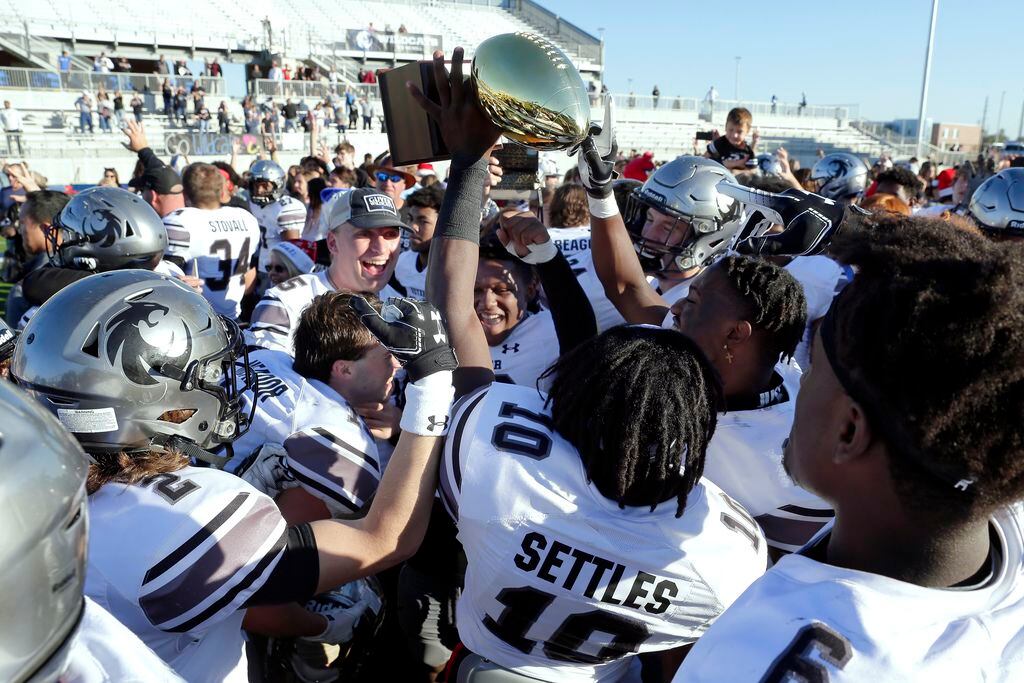 Guyer players hoist their trophy after defeating Spring Westfield 35-17 of their 6A Div. 2 state semi-final game Saturday, Dec. 14, 2019 at the Sheldon ISD Panther Stadium in Houston, TX.