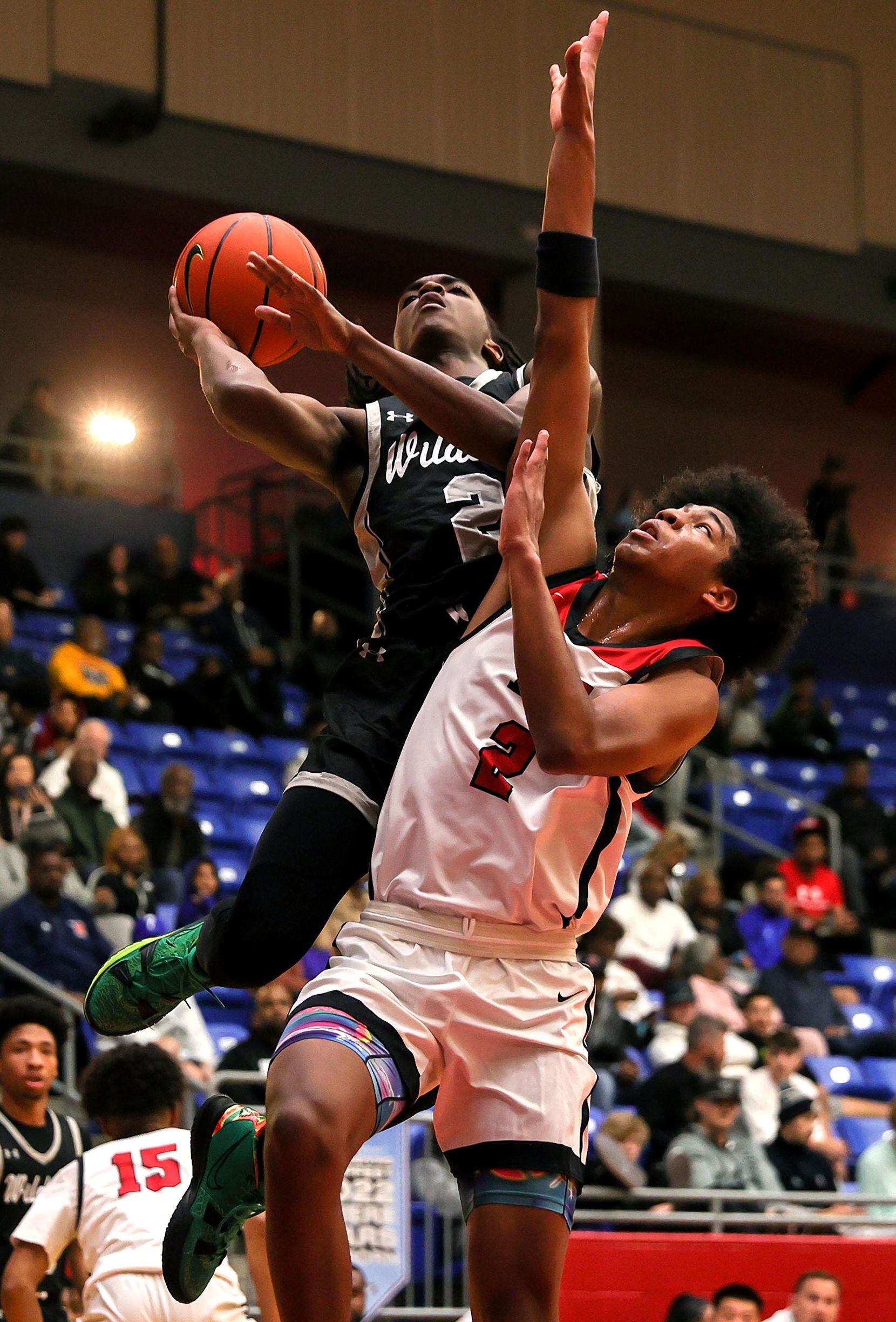 Denton Guyer guard Jeremiah Green (left) goes up strong to the basket against Harvard...