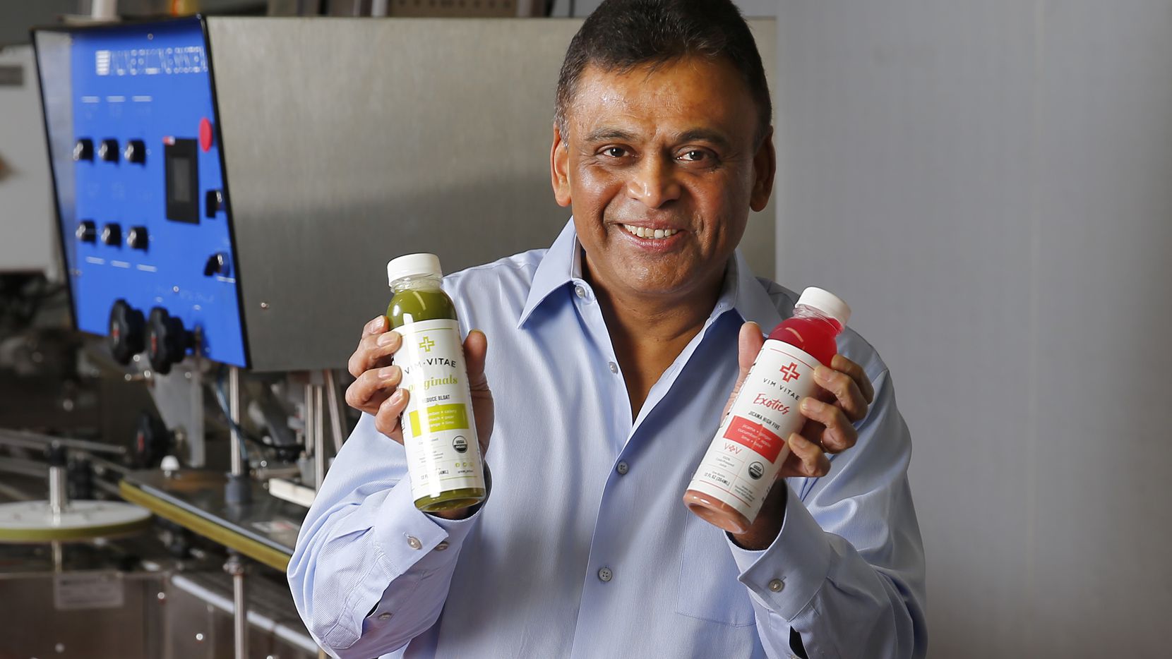 Vim Vitae CEO Nick Mysore poses with some of their natural, organic juices they produce at...