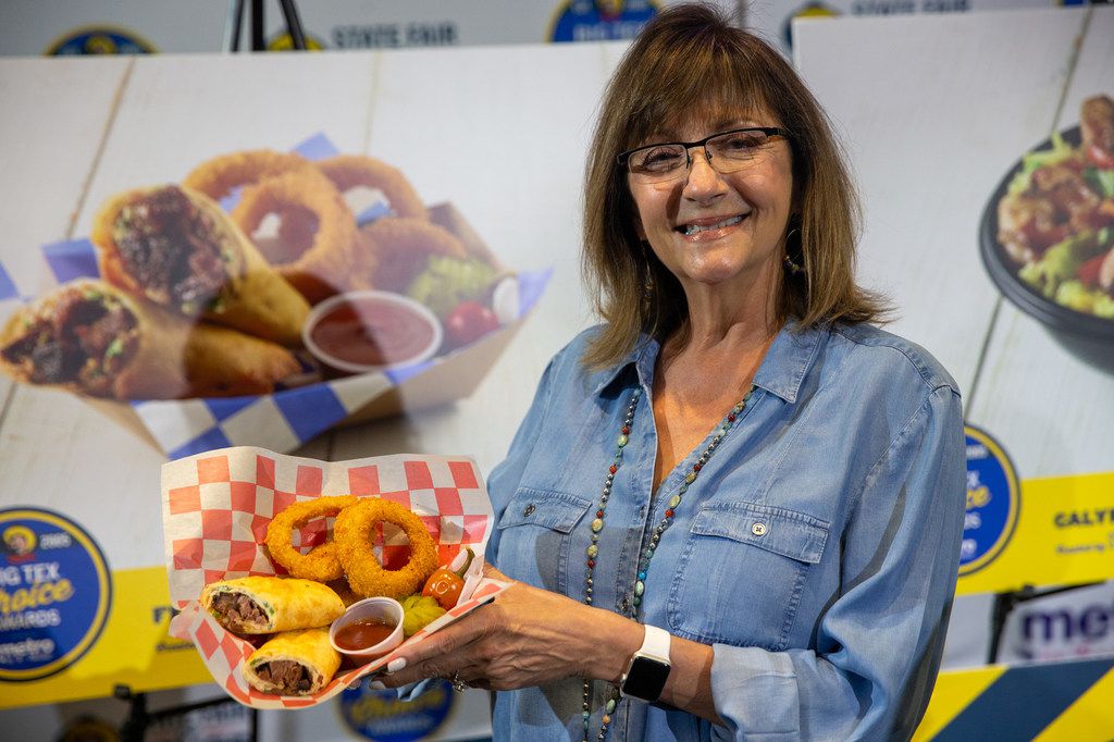 Christi Erpillo holds up Fernie's Fried Burnt End Burrito during the unveiling of the Big Tex Choice Awards. Erpillo has worked at the fair since she was a teenager.