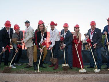 Richard Branson center and others toss first during the ground breaking for his Virgin Hotel...