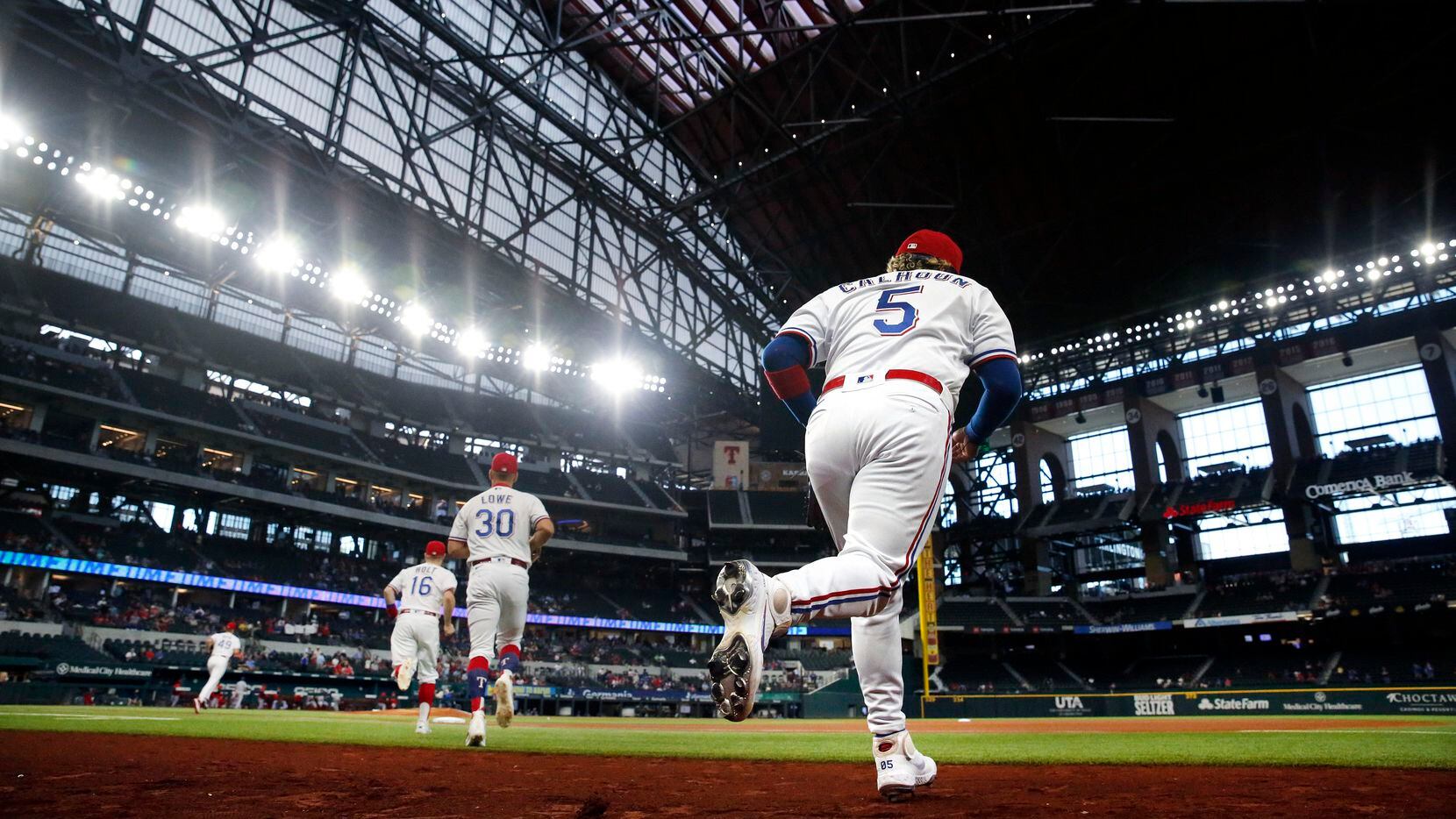 Texas Rangers left fielder Willie Calhoun (5) takes the field to face the Los Angeles Angels...