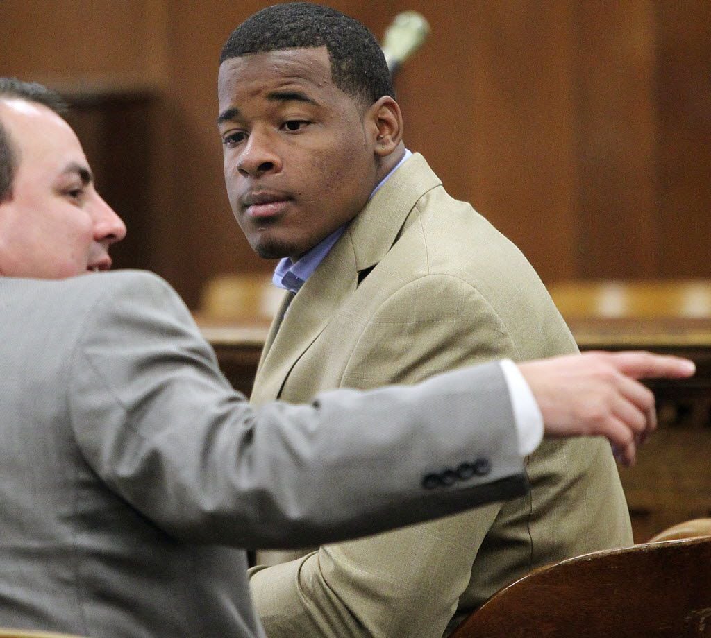 In this Jan. 23, 2014, file photo, former Baylor football player Tevin Elliott waits with a unidentified lawyer in a McLennan county courtroom in Waco, Texas. 