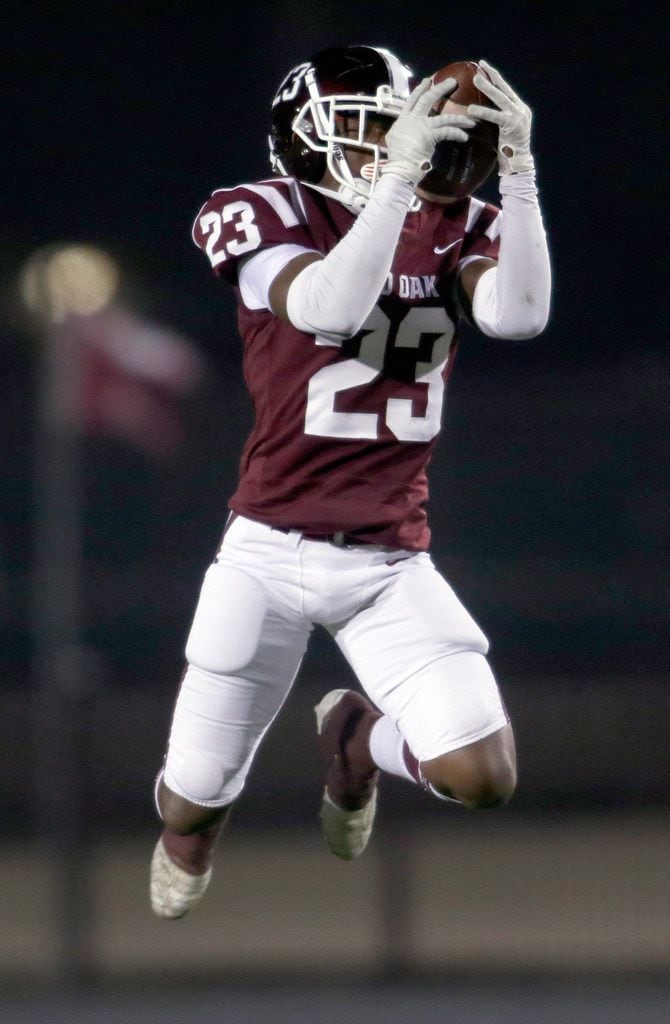 Red Oak defensive back Amarion Craddock (23) leaps to intercept a pass which set up a Hawks...