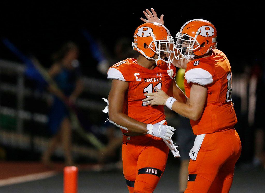 Rockwall's Jaxon Smith-Njigba (11) and Braedyn Locke (8) celebrate after connecting for a...
