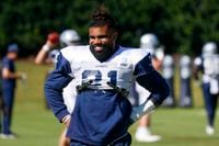 Dallas Cowboys running back Ezekiel Elliott (21) smiles during a team practice ahead of...