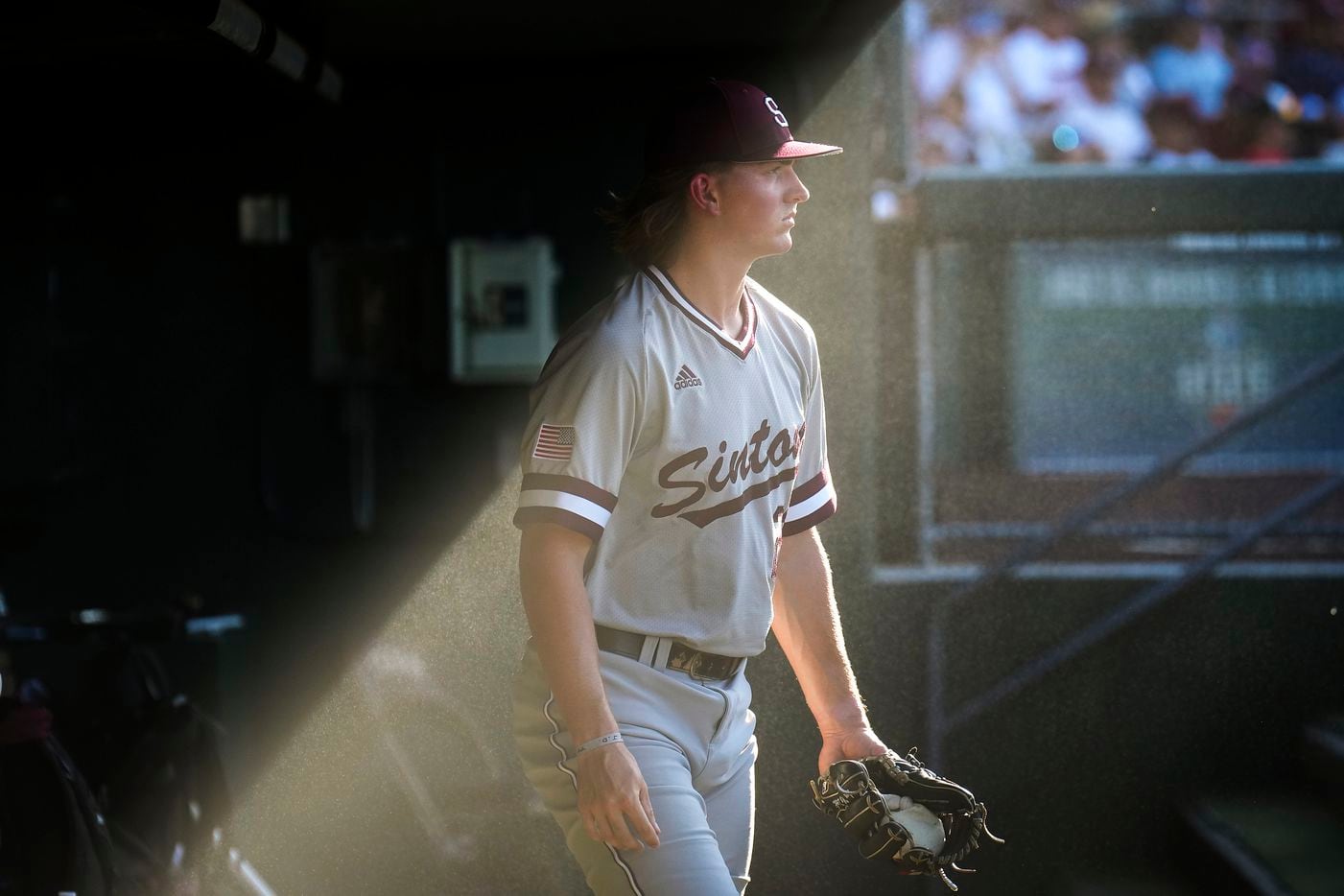 Sinton pitcher Wyatt Wiatrek (23) emerges from a cooling mist in the dugout before the UIL...