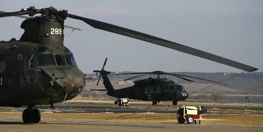 Chinook and Blackhawk helicopters of the Texas Army National Guard, stand ready to fight...