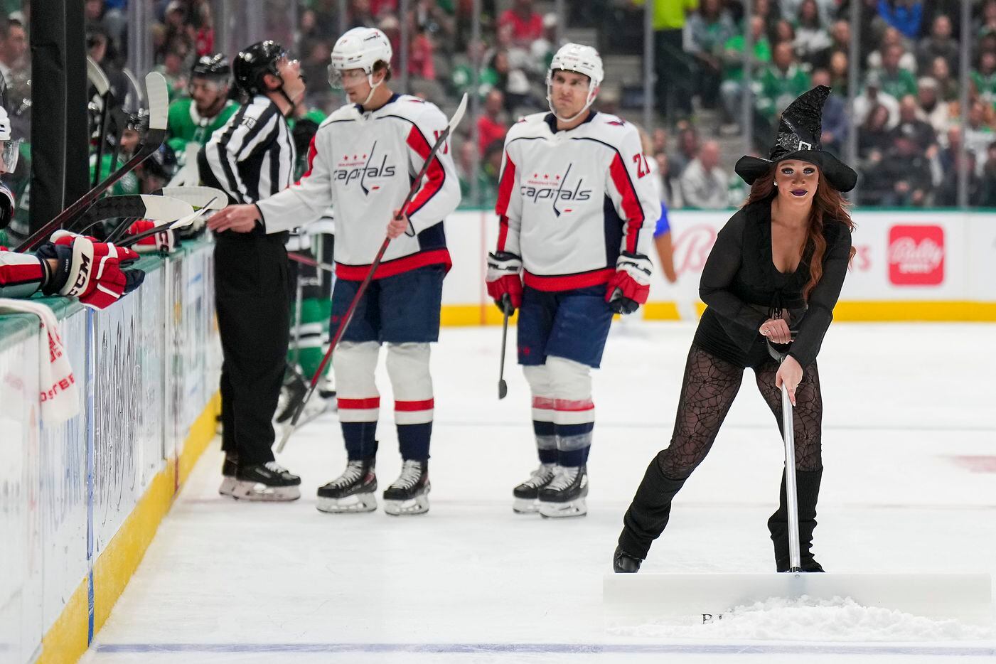 Dallas Stars Ice Girls wear Halloween costumes as they work on the ice during a timeout in...
