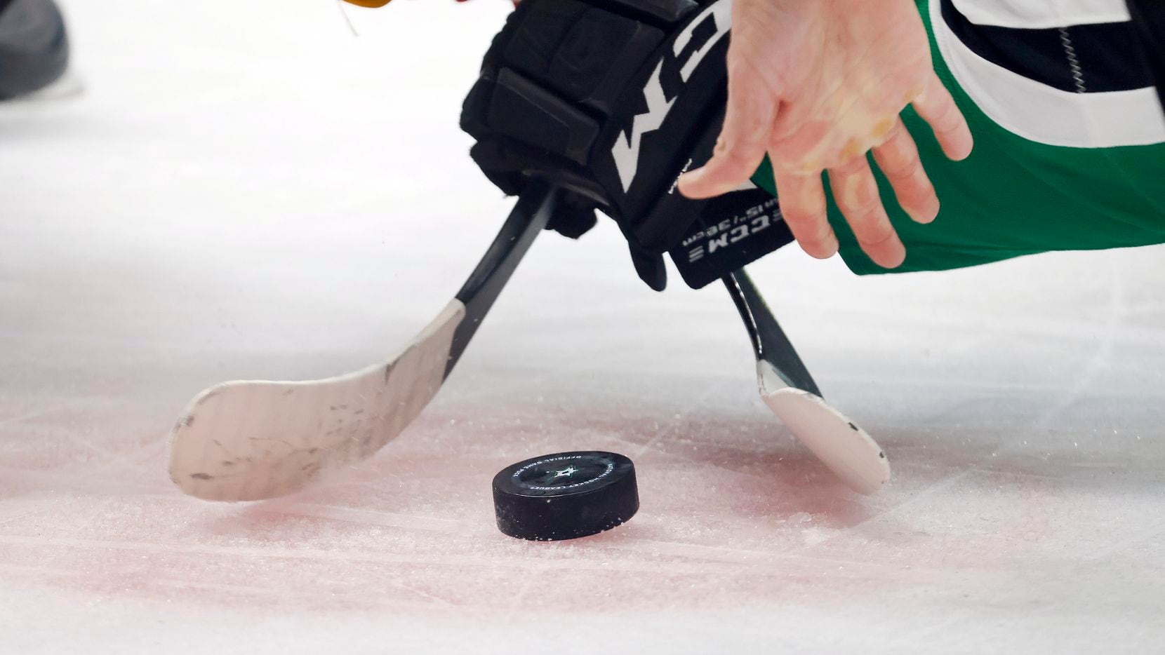 The referee drops the puck on a face off between the Dallas Stars and Calgary Flames during...