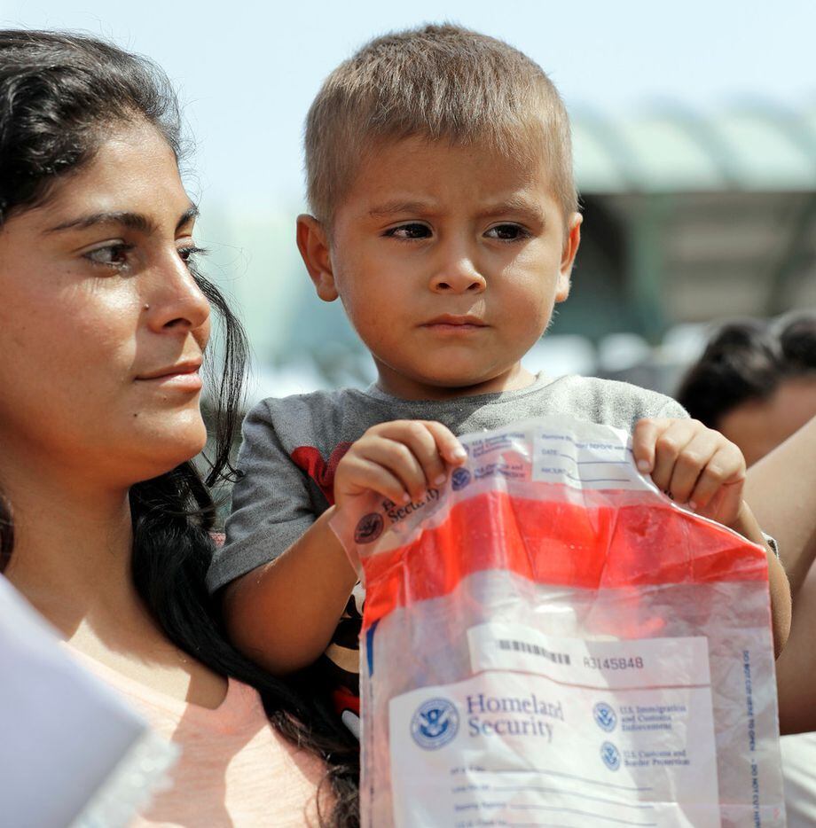 An immigrant child holds bag from Homeland Security as he arrives at the bus station after...