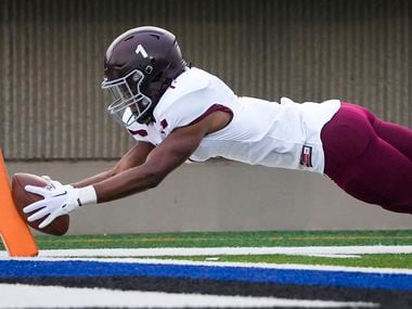 Mansfield Timberview running back Jarvis Reed dives for the pylon to score on a touchdown...