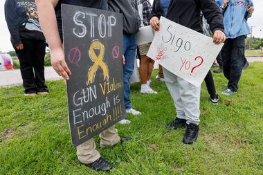 Students carry signs during a protest outside Wilmer-Hutchins High School, Monday, April 15,...