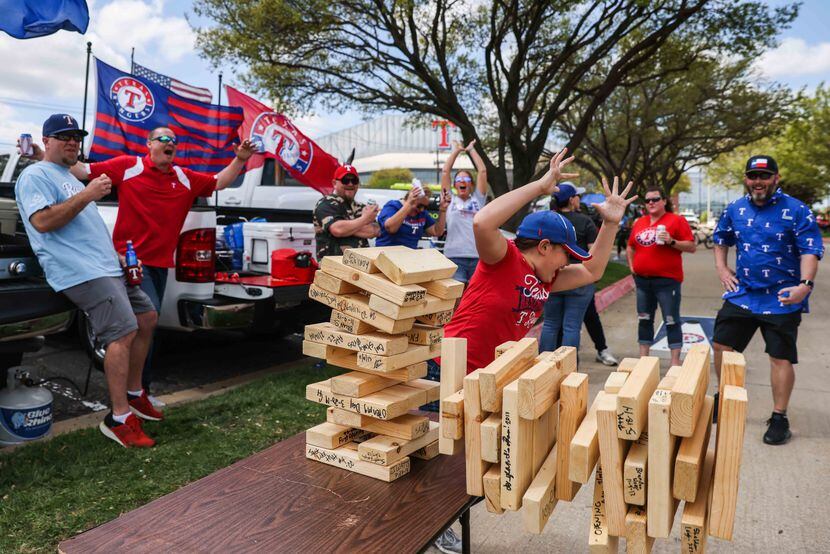 Sylar Watts, 11, reacted as a giant Jenga tower collapsed during a tailgate party outside...