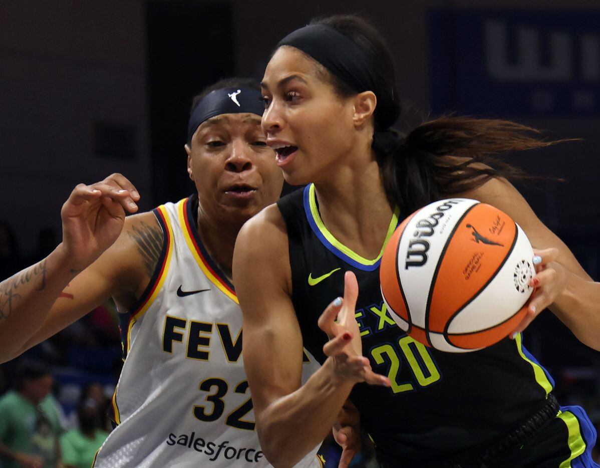 Dallas Wings forward Isabelle Harrison (20) drives to the basket as she is defended by...