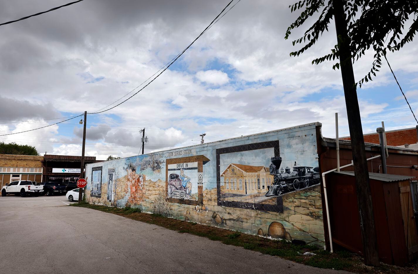 Weathered murals line the wall of a business in downtown Justin, Texas, August 23, 2022.