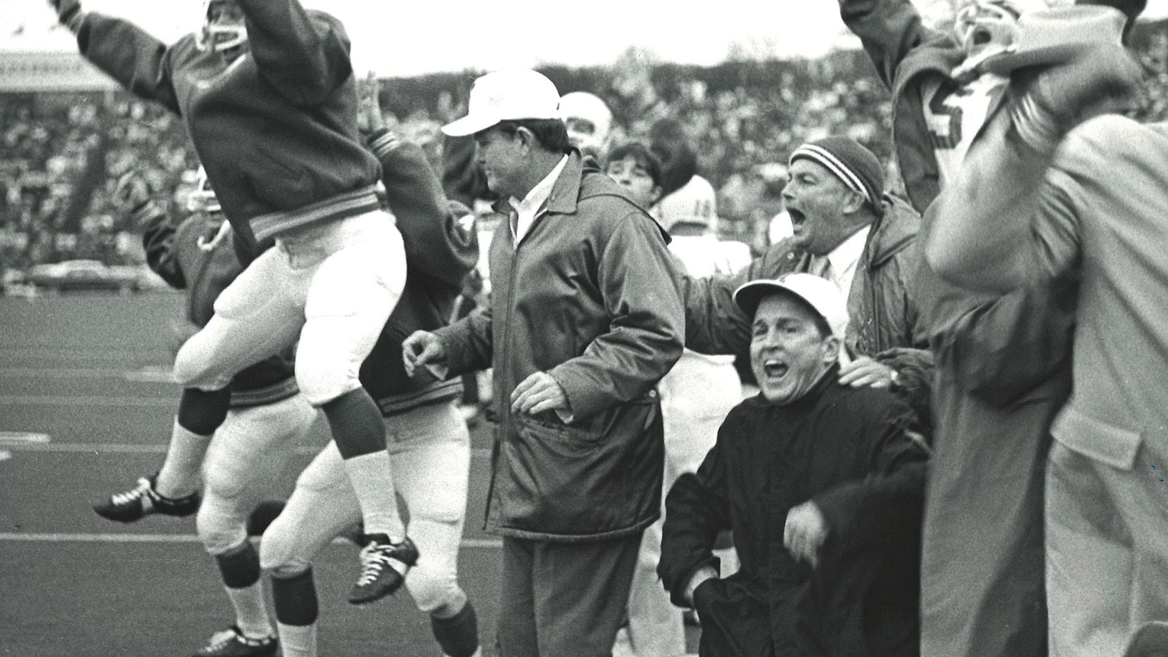Texas coach Darrell Royal (second from left) and his team reacted to the winning touchdown...