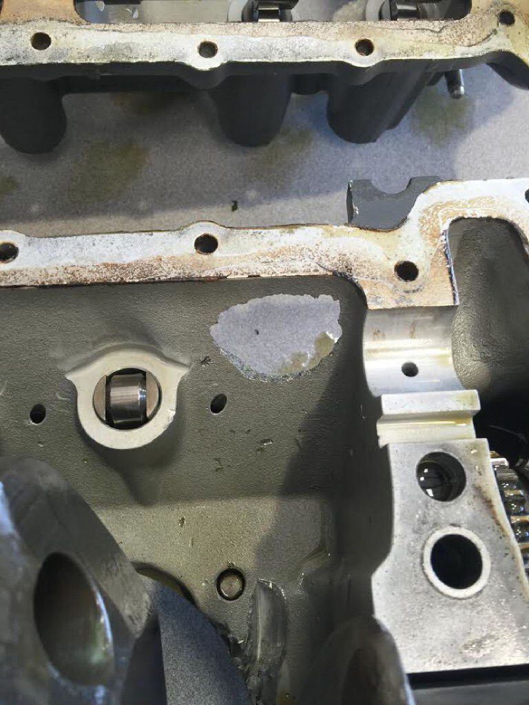 A photo provided by the FAA shows a hole (center) in the engine casing of the Cessna 172RG...