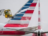 An American Airlines aircraft undergoes deicing procedures on Monday, Jan. 30, 2023, at DFW...