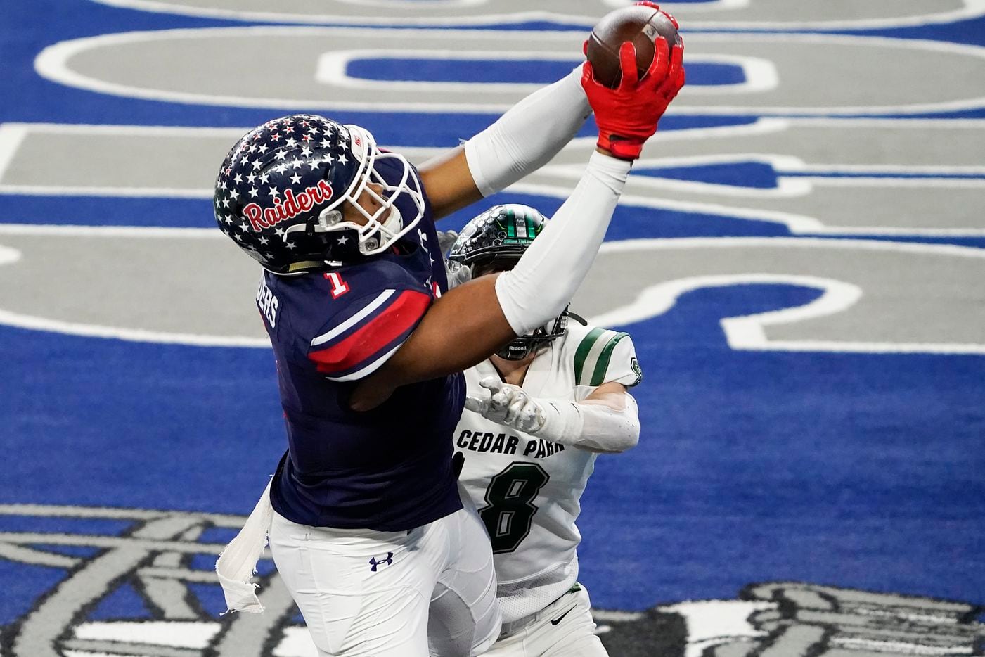 Denton Ryan wide receiver Ja'Tavion Sanders (1) catches a touchdown pass from quarterback Seth Henigan as Cedar Park defensive back Casyn Wiesenhutter (8) defends during the second half of the Class 5A Division I state football championship game at AT&T Stadium on Friday, Jan. 15, 2021, in Arlington, Texas. Ryan won the game 59-14. (Smiley N. Pool/The Dallas Morning News)