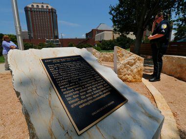 DART Corporal Barbara Underwood (right) reads the plaques for fallen Dallas police officers...
