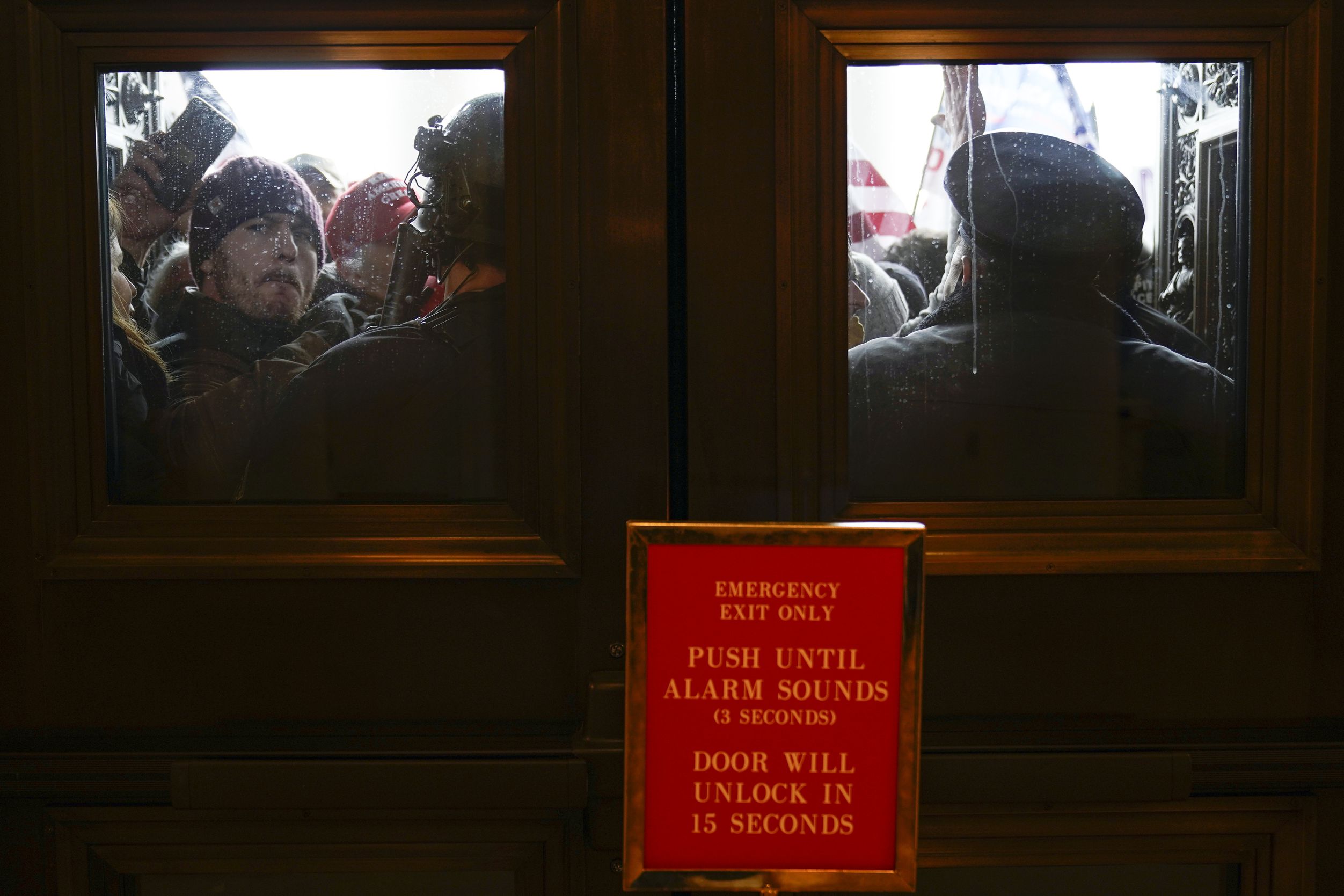 U.S. Capitol Police try to hold back protesters outside the east doors to the House side of...