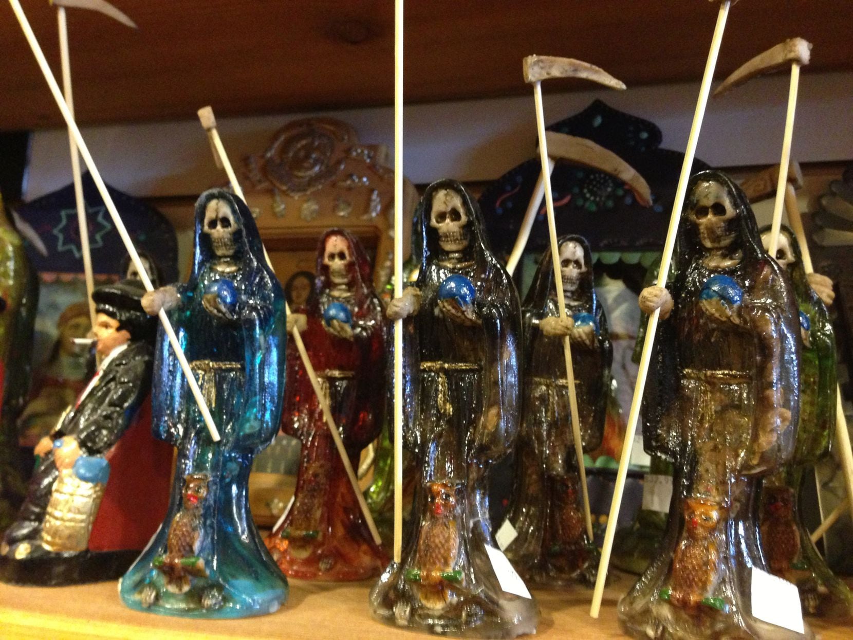 In this file photo, statues of Santa Muerte are shown at a store in Albuquerque, N.M. La...