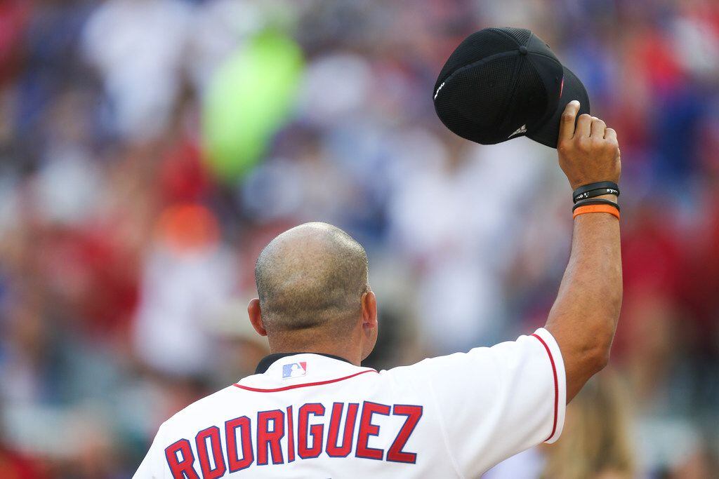 Former Texas Rangers catcher Ivan "Pudge" Rodriguez tips off the hat as he is introduced as...