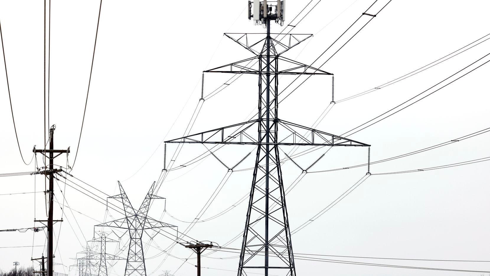 Large electrical transmission lines cross through South Arlington, Wednesday, February 17,...