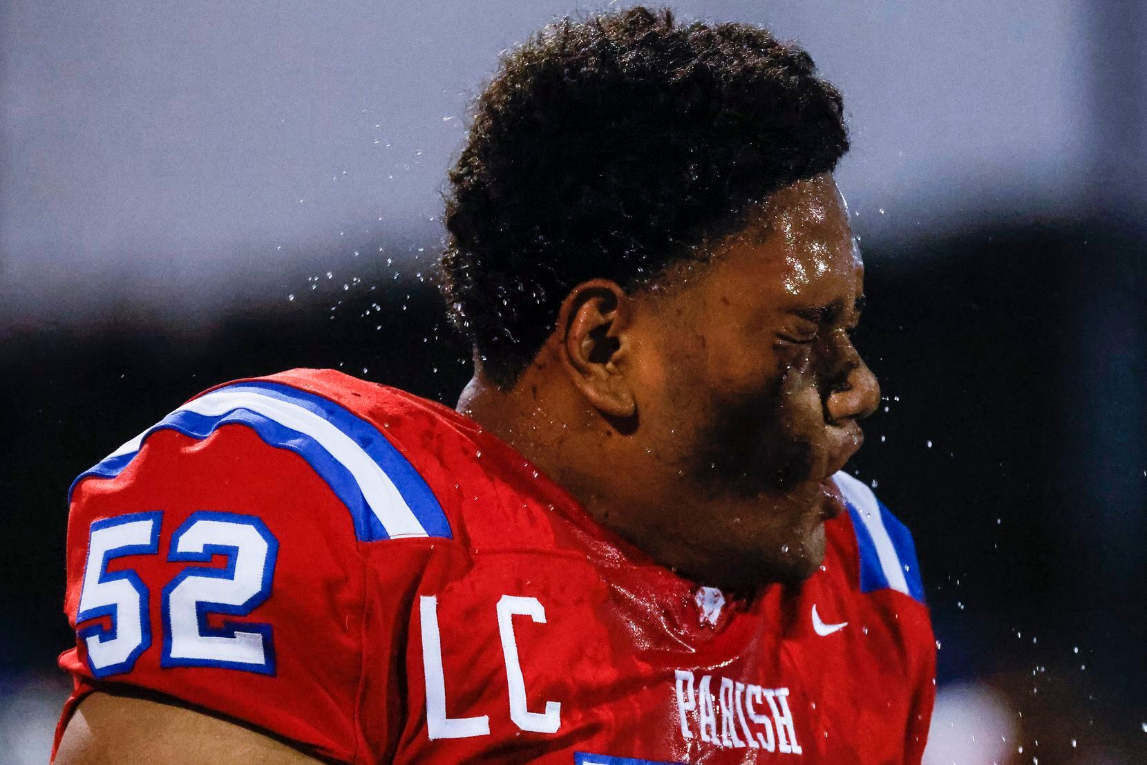 Parish Episcopal School’s Sam Liu (52) reacts as he cools off during the second half of a...
