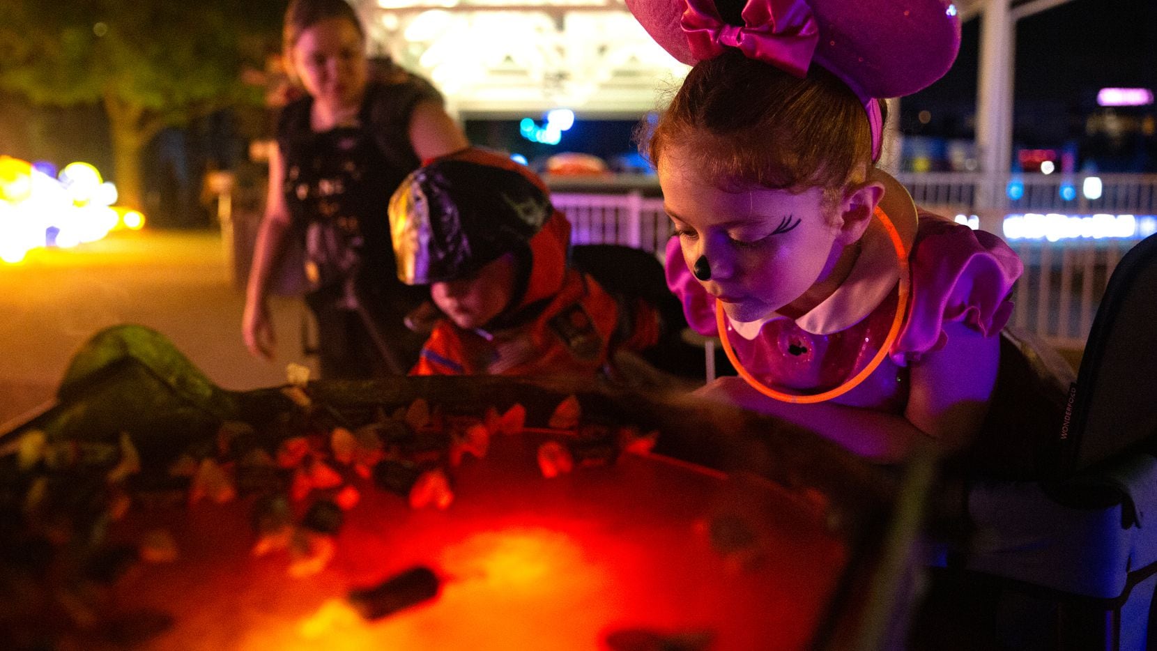 Aurora Deringer, 6, checks out the candy possibilities at a trick-or-treat station at Frights’n Lights at Riders Field in Frisco, TX on October 24, 2021. Frights’n Lights has the longest trick-or-treat trail in Texas. Another Frisco event(Shelby Tauber/Special Contributor)