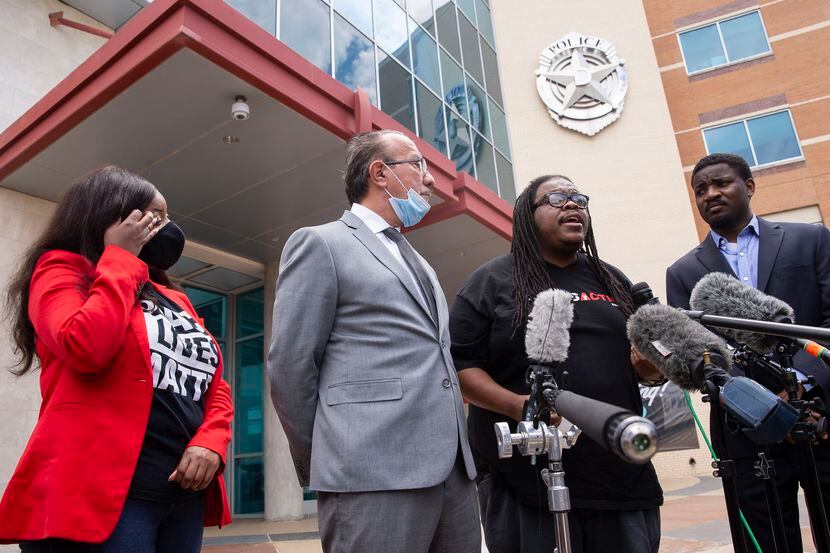 Dallas Police Oversight Coalition leader Changa Higgins (third from left) speaks along with...