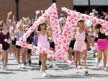 A group of newly picked Delta Gamma sorority pledgees run out of Bryant-Denny Stadium to their new sorority house after learning that they had been selected on the University of Alabama's bid day on Aug. 15 in Tuscaloosa, Ala.