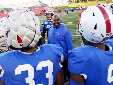 Defensive line coach Calvin Thibodeaux talks to his team after running run drills before the...