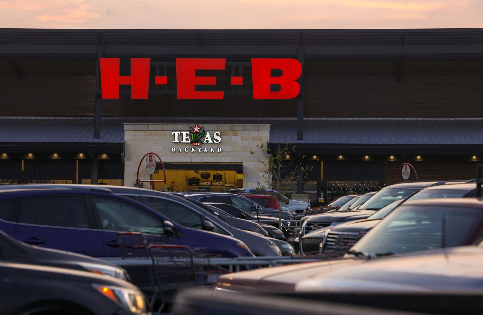 Cars fill the parking lot of H-E-B in Plano on Dec. 7. New H-E-B stores like this one and...