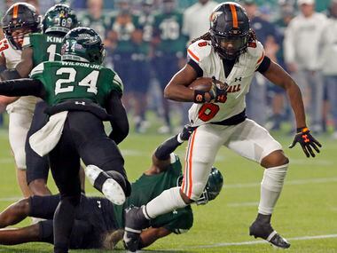 Rockwall’s Ashten Emory (6) drags a Waxahachie defender along, as he picks up a first down...