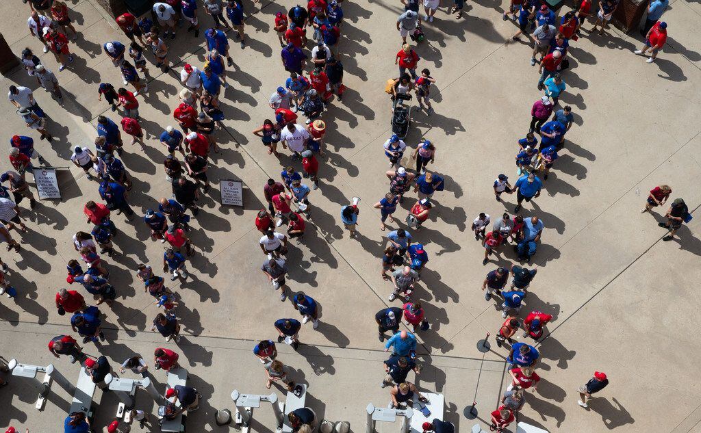 Texas Rangers fans wait to enter into Globe Life Park for the Rangers' final game ever...