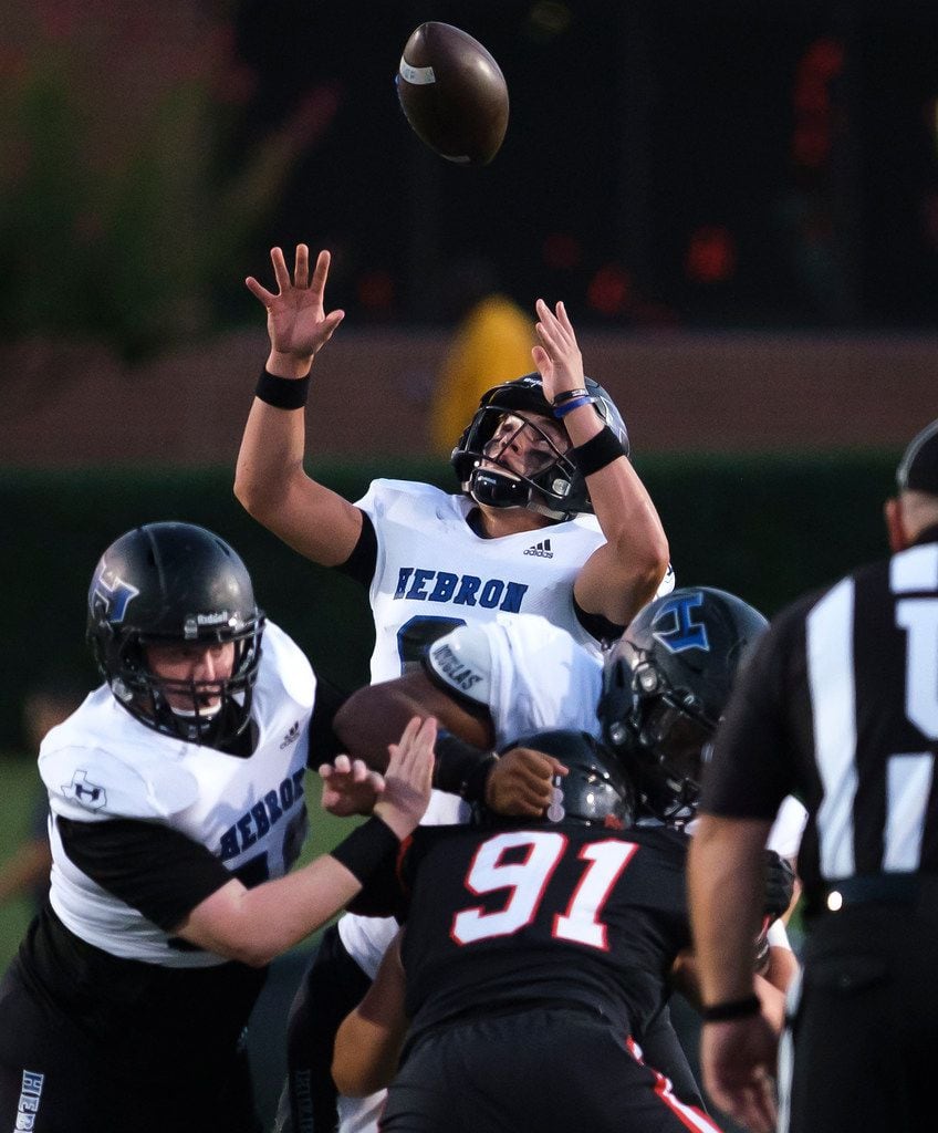 Hebron quarterback  Caron Harris (8) kreaches for a high snap during the first half of a high school football game against Coppell on Friday, Oct. 4, 2019, in Coppell, Texas. (Smiley N. Pool/The Dallas Morning News)