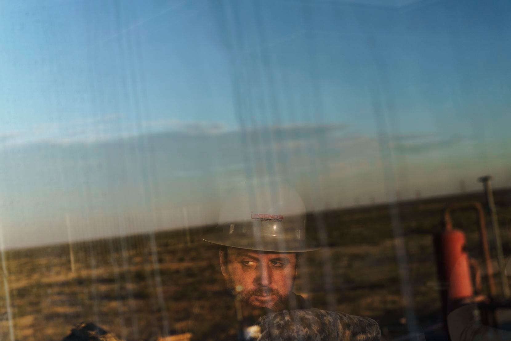 Well site supervisor Jason Brown looks out toward the Permian Basin from the control room of...