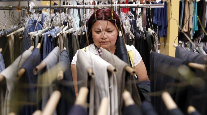This file photo shows Janice Compos of Garland looks for clothes for her family at Network...